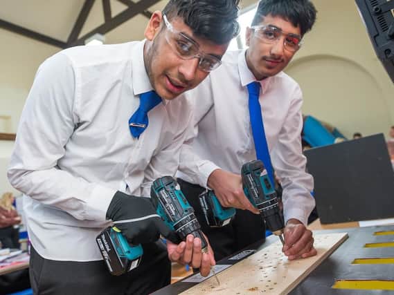 Tanvier Khalique  and Mohammed Saqlain get to grips with drills at the careers event held at Burnley's Coal Clough Academy.