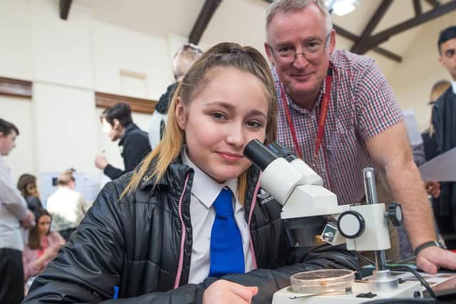 Gracie Howard Grear looks at life under a microscope at the careers event at Coal Clough Academy in Burnley.