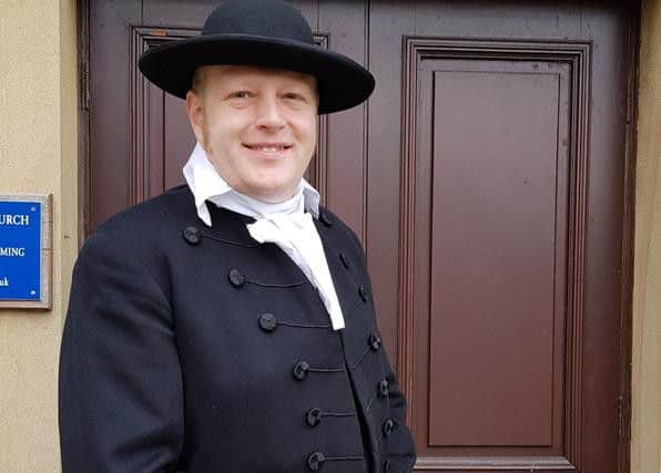 Church member Nick Mitchell dressed as first minister William Wilkinson.