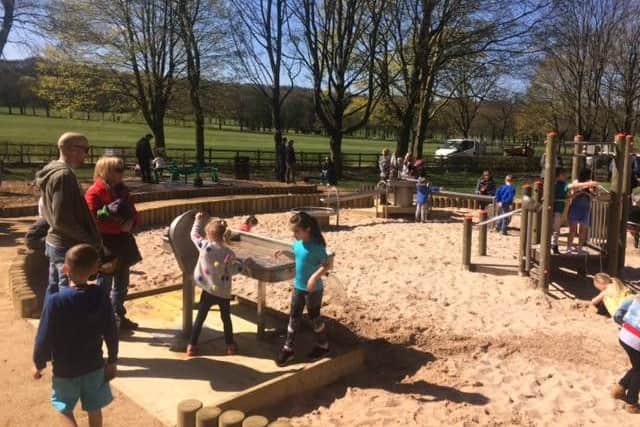 Youngsters have fun on some of the new equipment at the riverside park at Towneley in Burnley.