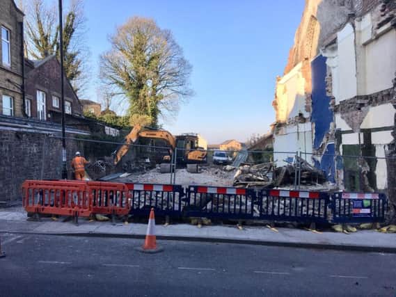 Demolition crews on site as two historic buildings are knocked down