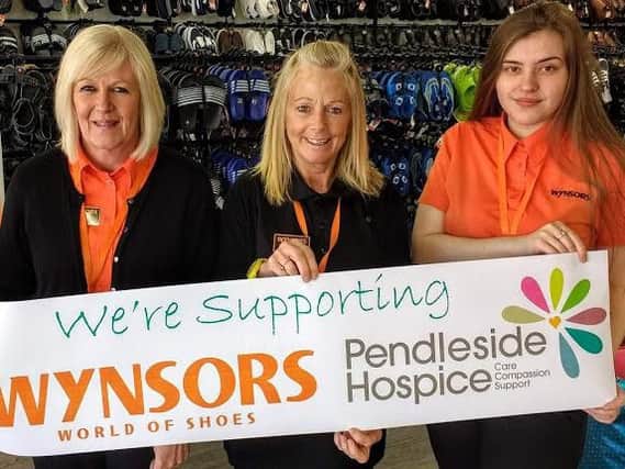 Staff at the Wynsors World of Shoes in Burnley, which has named the Pendleside Hospice as its new fund-raising partner. (s)