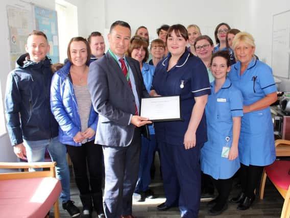 Midwife Sister Rebecca White (centre) receives the Employee of the Month Award from Chief Executive Kevin McGee, surrounded by Birth Suite colleagues alongside (left) Simon and Carla Thompson.