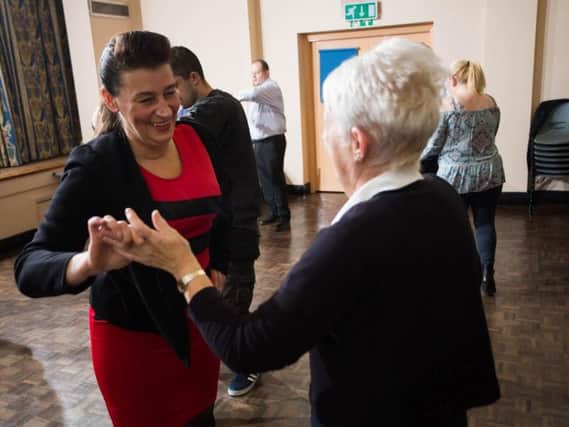 Michelle Hurlstone (left), Independent Living Officer for Calico Homes, practices her dance moves.