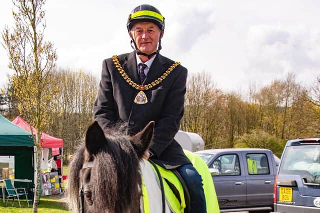 Mayor of Burnley, Coun. Charlie Briggs, and Henry, a traditional Cob, leading a road safety campaign ride. (s)