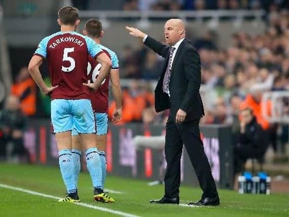 Burnley manager Sean Dyche (right) speaks with Burnley's James Tarkowski during the Premier League match at St James' Park, Newcastle.