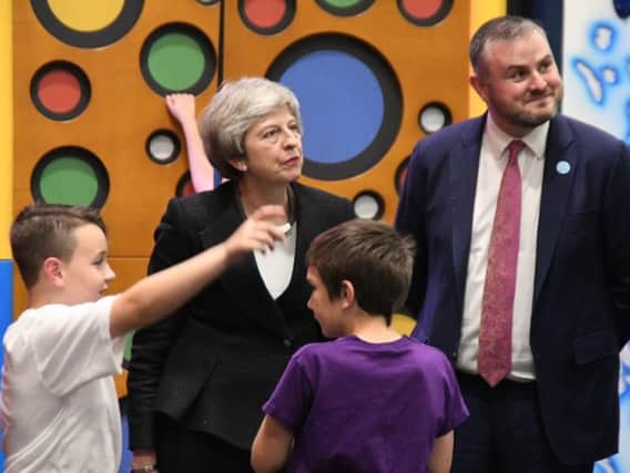Prime Minister Theresa May and Pendle MP Andrew Stephenson chatting with two youngsters at the Leisure Box in Brierfield