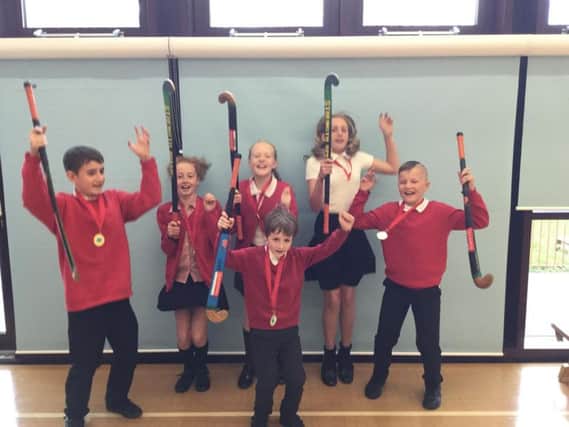 The winners! The triumphant team from Earby Springfield Primary School celebrate their win in the Pendle School hockey tournament.