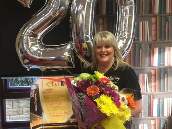 Angela Fielden is celebrating 20 years at a Slimming World consultant.