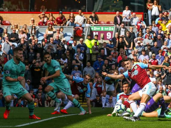 Burnley's Matthew Lowton sees his shot blocked by Arsenal defender Shkodran Mustafi in the final game of the season at Turf Moor