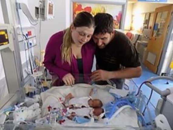 Max Bridges and his wife Emily with their two sons following their birth.