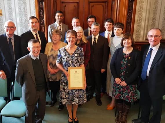 Janet Westmoreland (centre front) with her Certificate of Honour, which she received at the town hall from the Mayor of Burnley, Coun. Charlie Briggs,on behalf of the council. (s)