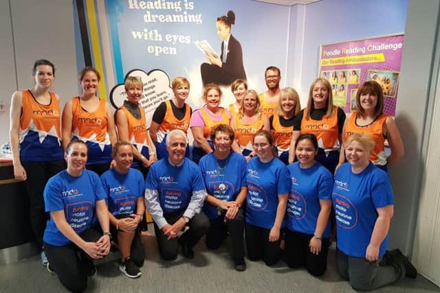 Staff from Pendle Vale who will run the Manchester 10k this weekend memory of their colleague Dani Wallace. Organiser Laura Laycock is on the back row (second from left) and headteacher Steve Wilson is on the front row third from the left.