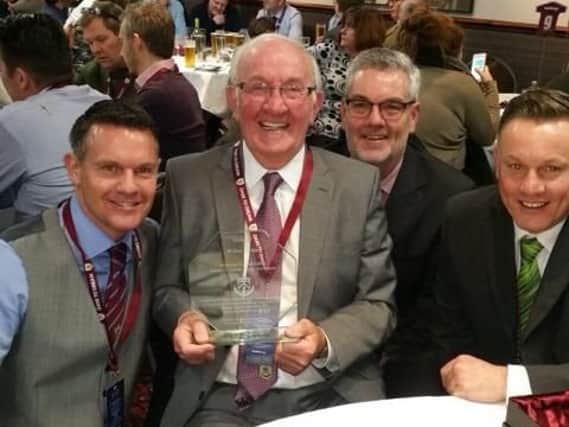 Jonathan (left), Mr Irvine, Darren and Stephen at an event commemorating 50 years since Mr Irvine became the post war leading goalscorer for 29 league goals in a season, which he still holds. Barry Kilby presented it at half time vs Brighton, another one of Mr Irvine's former clubs.