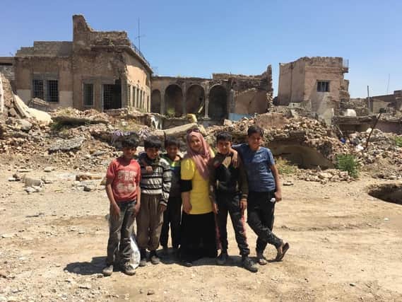 Humeira Bibi with local children in the war-ravaged Iraqi city of Mosul