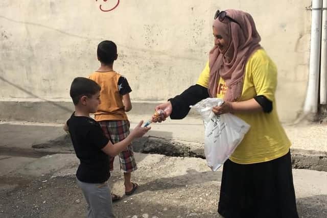 Humeira making sure local children are fed
