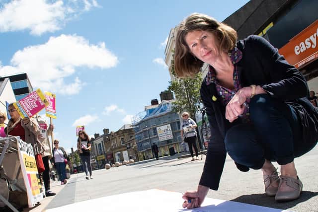 Gina Dowding who is the MEP Green Party candidate, signs the statement protesting against Tommy Robinson's visit to Burnley.