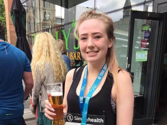 Jodie in celebration mode after completing the Manchester 10k to raise 700 plus for charity.