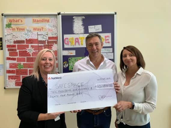 Steve and Lisa Nicholas (right), event organisers of the Fence Charity Ball, handing over a cheque for 10,184 to Claire Bennet, charity manager of SafeSpace. (s)