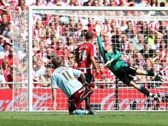 Wade Elliott watches his effort beat Paddy Kenny for the winner at Wembley