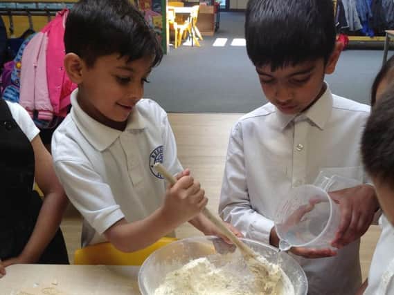 The Reedley Primary School children measuring out their ingredients to make the pizza dough.