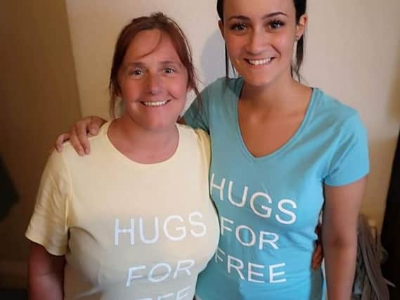 Viv (left) and Katie are on a mission to make people smile and feel better with the Hugs for Free project.
