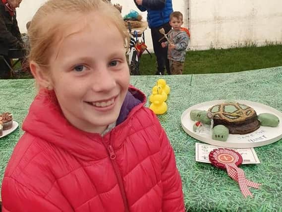 Burnley schoolgirl Holly Hope with her turtle cake which won her first prize at an agricultural show.