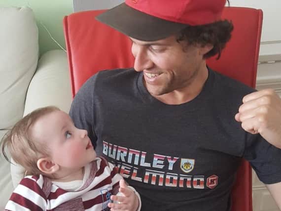 Willem van Hout (36) with his five-month-old daughter Jeske, both of them wearing Burnley & Helmond attire.