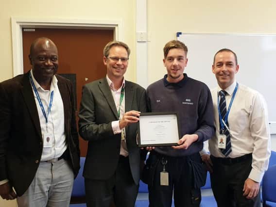 Director of Service Improvement Martin Hodgson (centre left) presents Sean with
his East Lancashire Hospitals Employee of the Month certificate, flanked by colleagues Andrew Appiah and Larry Cottey