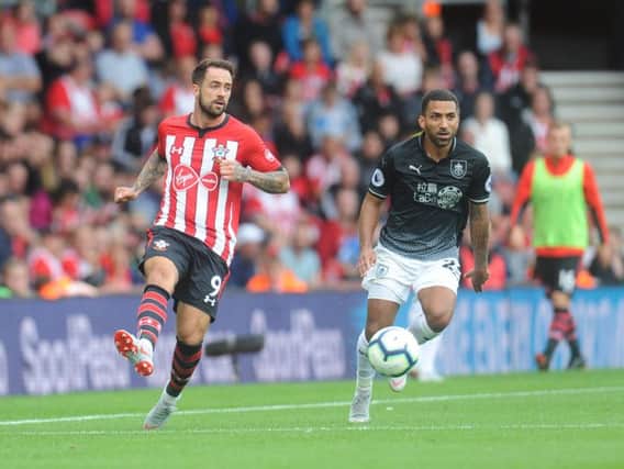 Former Claret Danny Ings lays the ball off as Aaron Lennon looks on during last seasons Premier League opener at Southampton