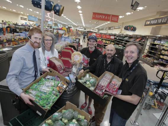 Staff at Burnley's Aldi store with a selection of food that is going to be donated to vulnerable people in the area