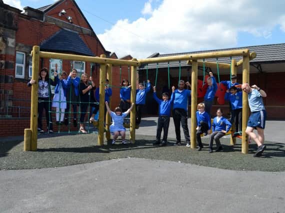 Heasandford Primary School pupils enjoying new health-boosting playground equipment, which has been installed thanks to a 10,000 Heritage Lottery grant.