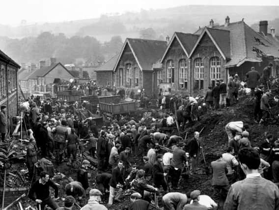 Rescue workers searching for victims of the Aberfan Disaster of 1966, which killed 144 people, including 116 children.