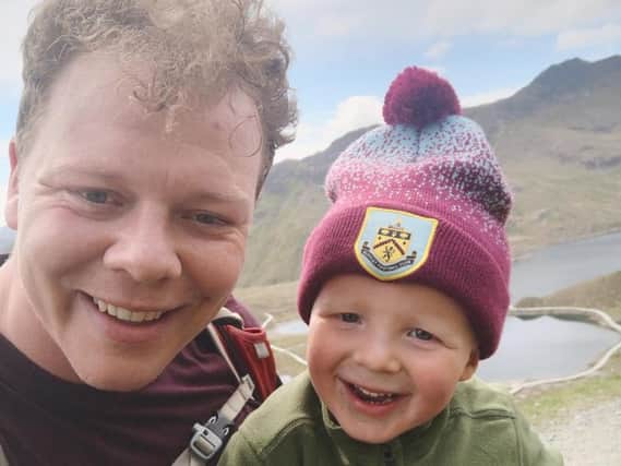 Little Jaxon Krzysik, who has become the youngest person to climb Britain's highest mountains, with his dad Cal.