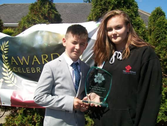 Mason and Melissa with the award they won for The Rose School.