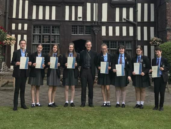 It's double celebrations as pupils also achieve the CYMFED Silver Award from Bishop John Arnold