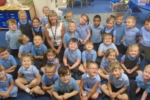 Mrs Susan Fallows surrounded by some of the children who have been in her charge at Holy Trinity Primary School in Burnley.