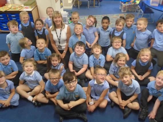 Mrs Susan Fallows surrounded by some of the children who have been in her charge at Holy Trinity Primary School in Burnley.