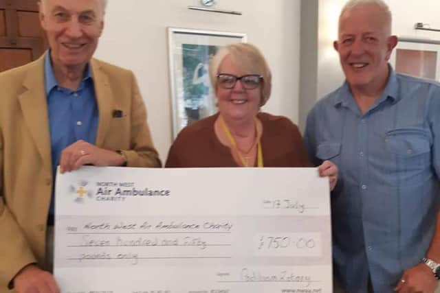 Dave Alexander (right) who is vice president of Padiham Rotary Club presents a cheque to Freda Whittle of the North West Air Ambulance with fellow rotarian Barry Brown.