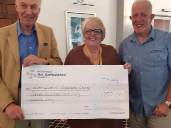 Dave Alexander (right) who is vice president of Padiham Rotary Club presents a cheque to Freda Whittle of the North West Air Ambulance with fellow rotarian Barry Brown.