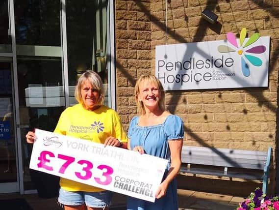 Barrowford Slimming World leader Janet Barnes hands a charity cheque to fund Christine Cope, who works for Pendleside Hospice.