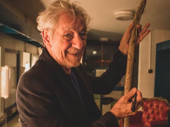 Sir Ian McKellen signs the staff used in the Dukes outdoor theatre production of The  Hobbit. A lottery will give fans the chance to win the signed staff