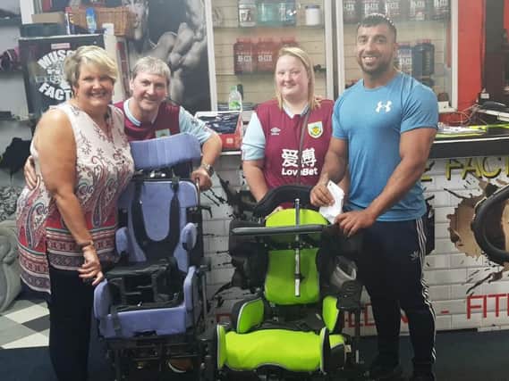 Tariq receives the equipment from Linda and her husband John and their daughter Hannah.