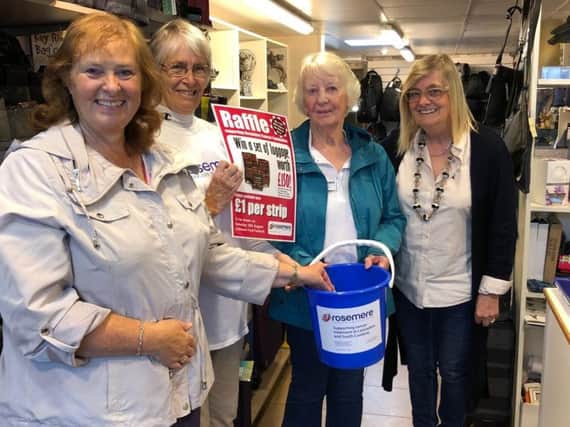 From left, festival visitor Janice Ellis, draws the raffle watched by Rosemere volunteers Doreen Hammond and Rosalie Cook with Christine Gainsley.