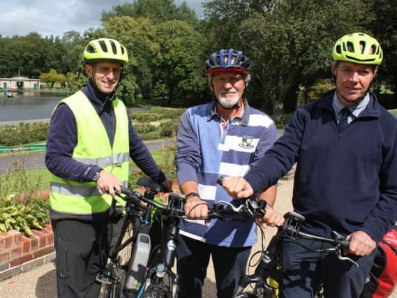 Coun. Emo (centre) with parks officer Sean Kerr (left) and head of greenspaces Simon Goff with one of the electric bikes at Thompson Park.
