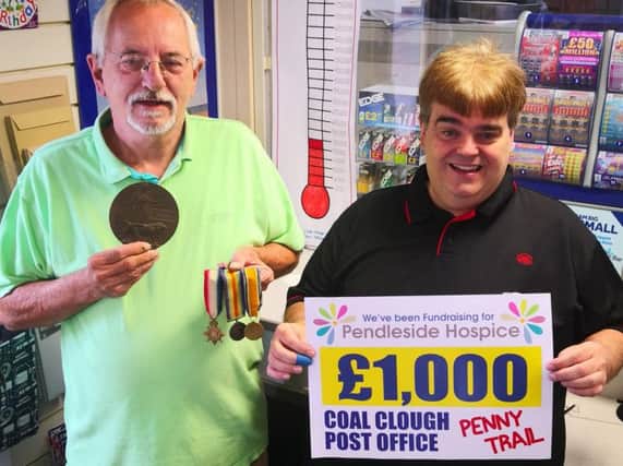 Peter and Steven are blazing the trail at Coal Clough Lane Post office to collect one million pennies for Pendleside Hospice.