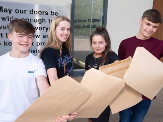 Students from Burnley's Blessed Trinity RC College celebrate their GCSE results