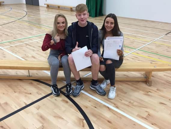Thumbs up for this trio of successful GCSE students at Burnley High School