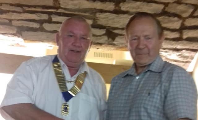 Stephen Hunt (left) receives his chain of office for his new role as the president of Burnley Lions from retiring president Frank Seed.