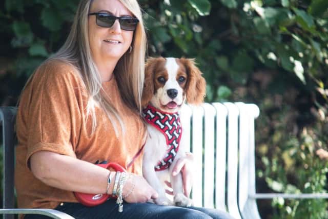 Melanie Hunt and Chester the puppy on the memorial bench in honour of her son Ethan who died last year aged 16.